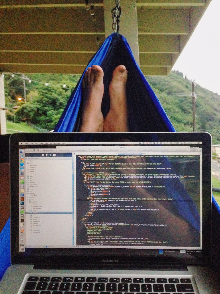 My laptop on my knees as a I lay in a hammock