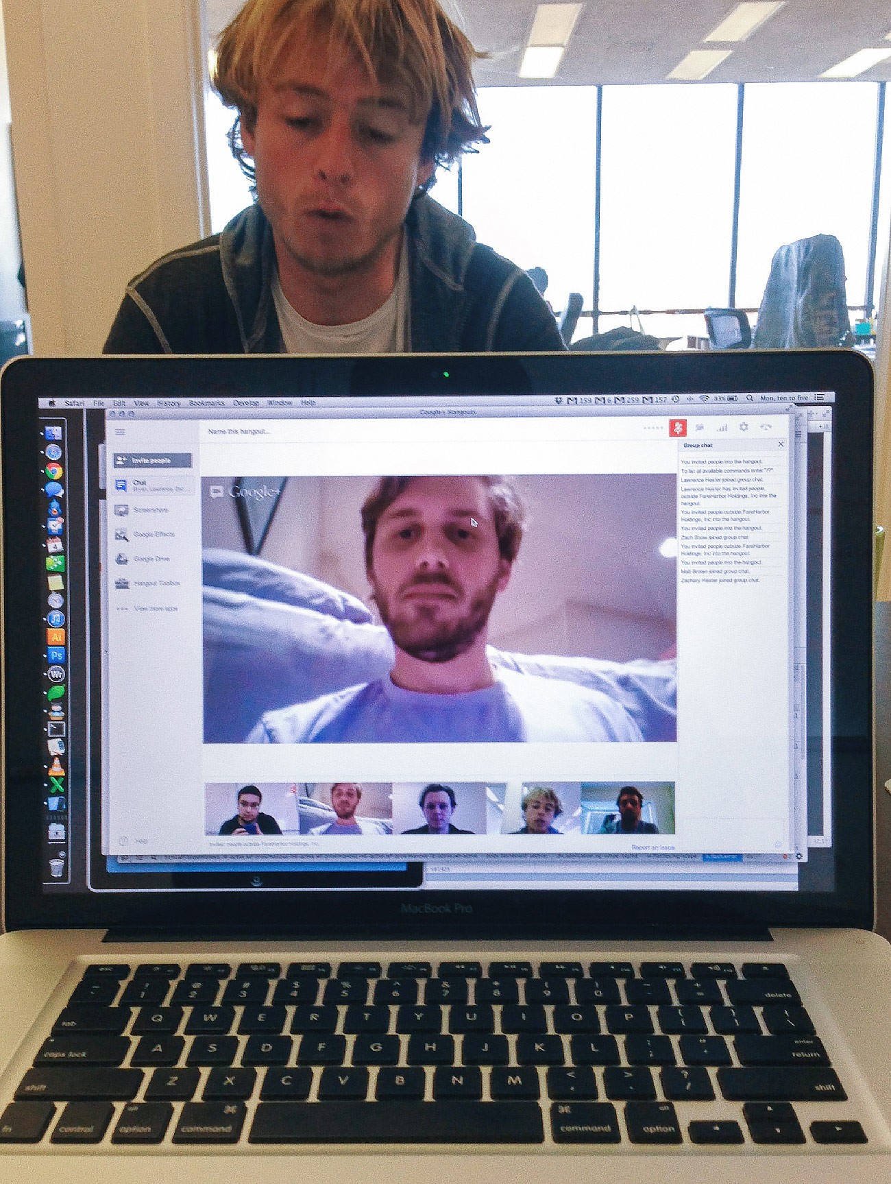 Laptop of a video call, with Zach in the background