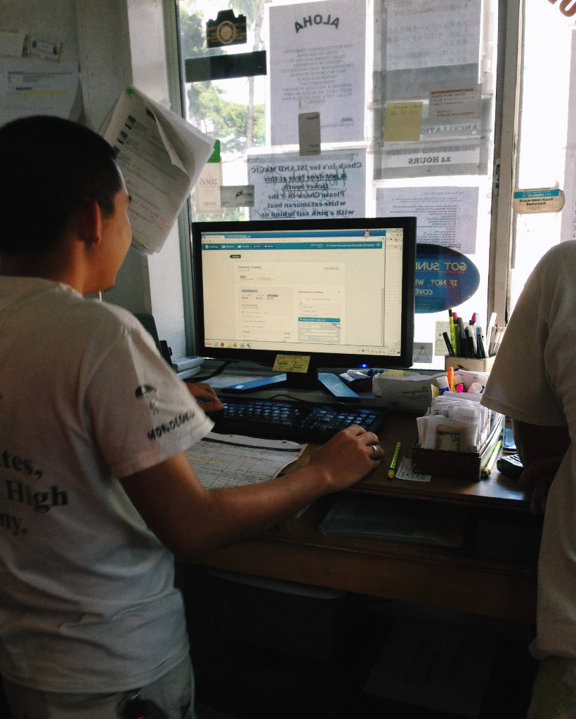 A man using a computer in a reservation booth